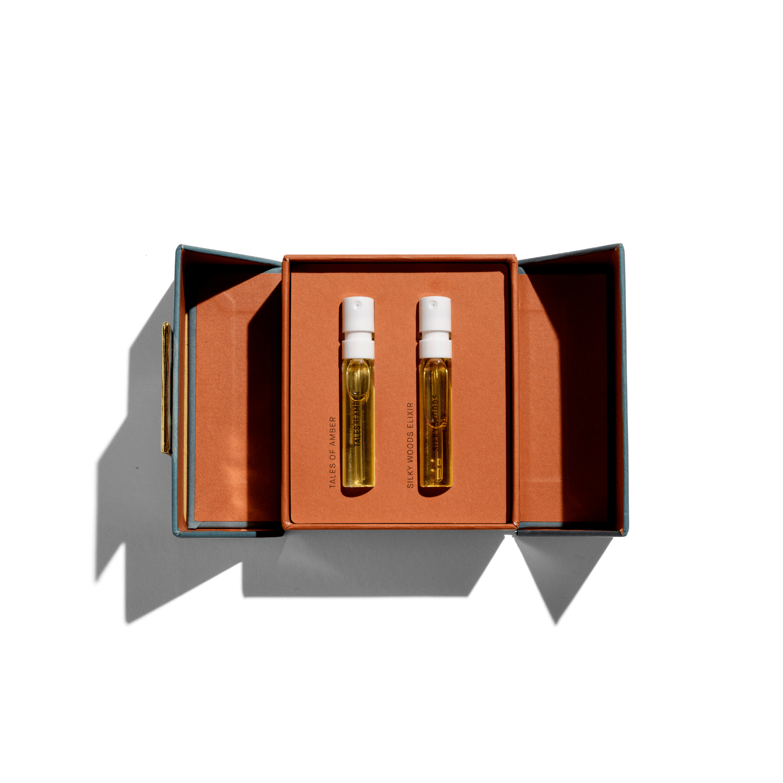 Discovery Set with Tales of Amber and Silky Woods Elixir Duo in an open orange box
