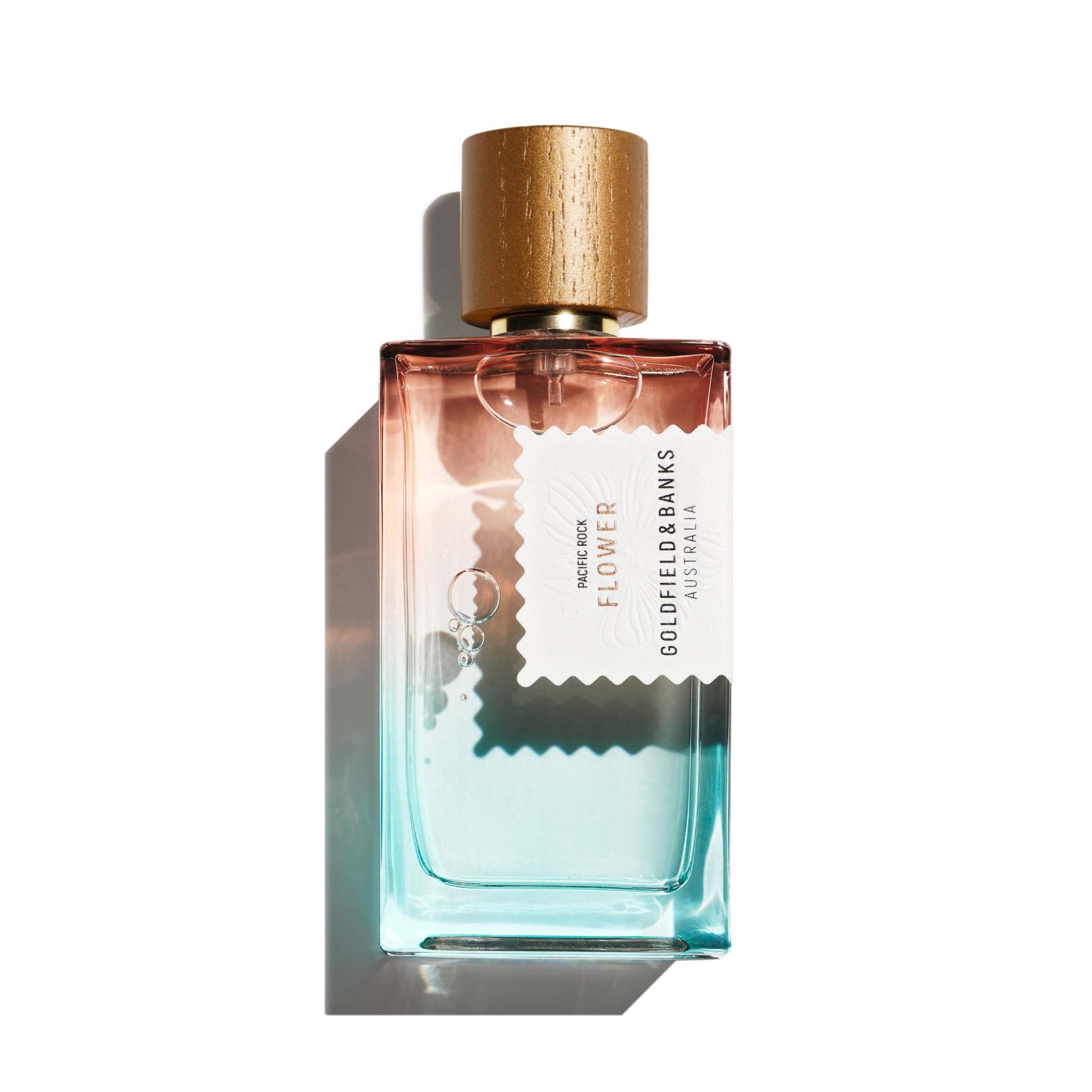 Pacific Rock Flower perfume bottle with gradient blue and pink glass and wooden cap