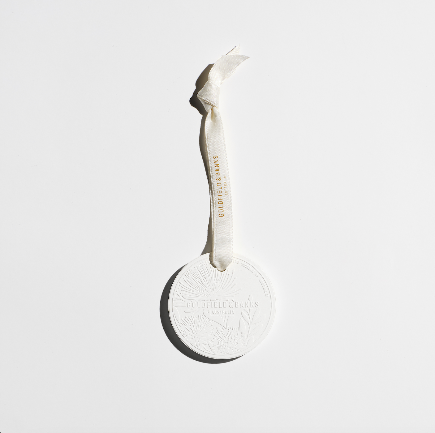 Mystic Bliss scented white ceramic ornament with embossed design and hanging ribbon