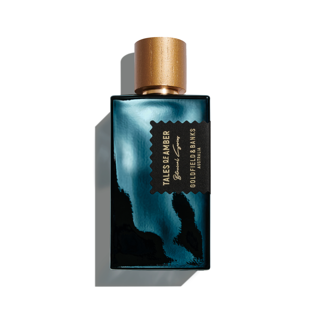 Tales of Amber perfume bottle with black and gold design and wooden cap